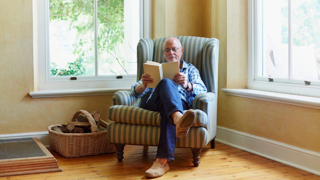 senior man reading at home