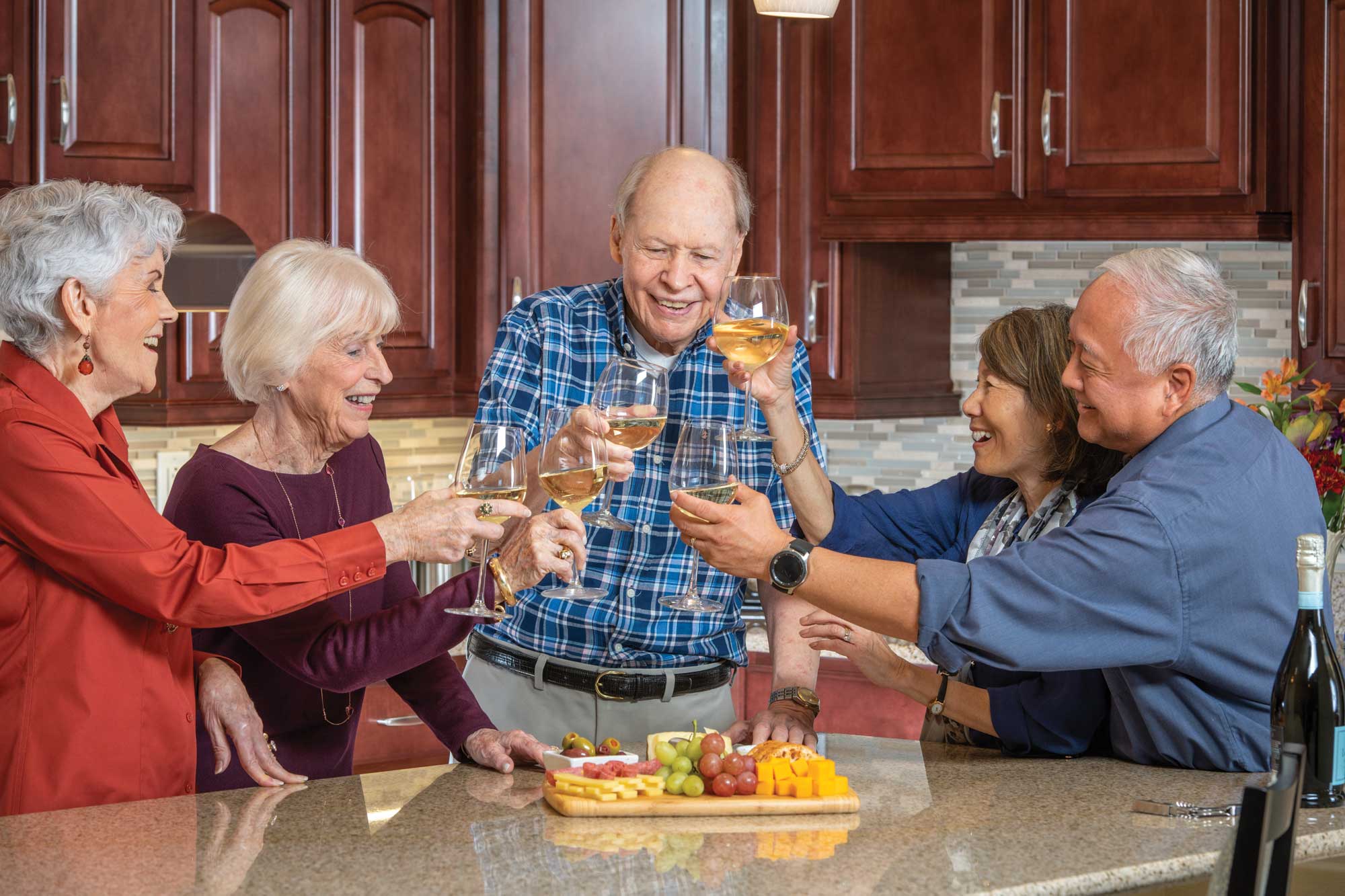 The Terraces residents gathered in a home kitchen for wine and cheese