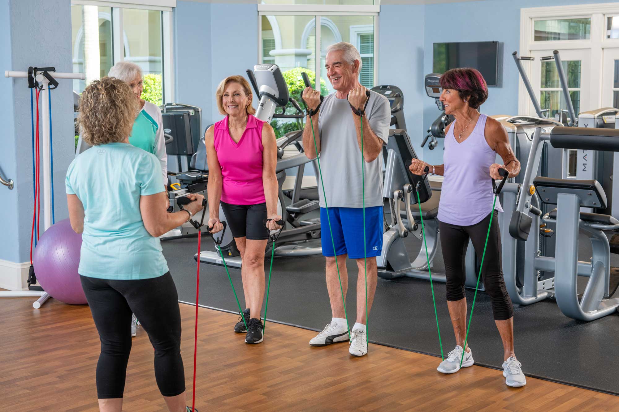 a fitness instructor guiding a group of seniors in a fitness class